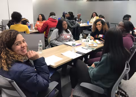 students sitting around tables talking
