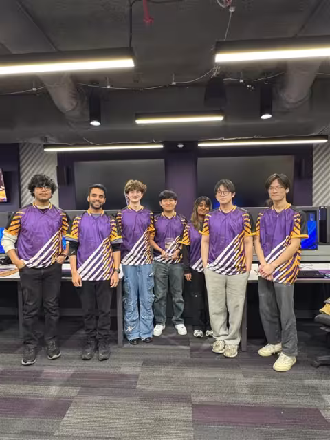 The UAlbany Esports Valorant team stands together for a photo in their jerseys.