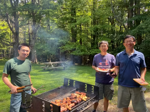 The UAlbany Asian Coalition of Professionals guests grilling outside