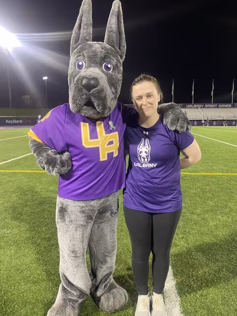 Zoe Veaunt stands next to Damien on Bob Ford field.