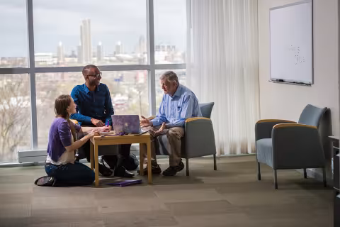 Three people working in an office on UAlbany's Health Sciences Campus.