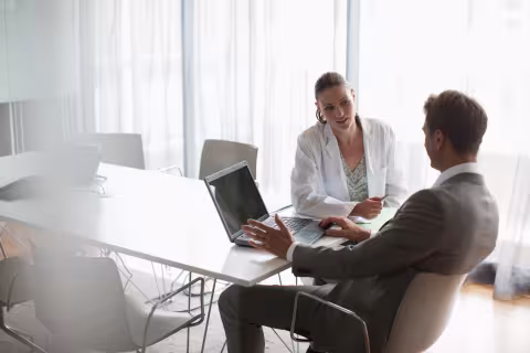 Businessman working with scientist in conference room