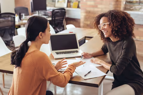 Two women having a discussion in an office