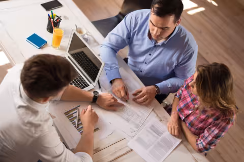 Above view of a couple meeting with a financial advisor