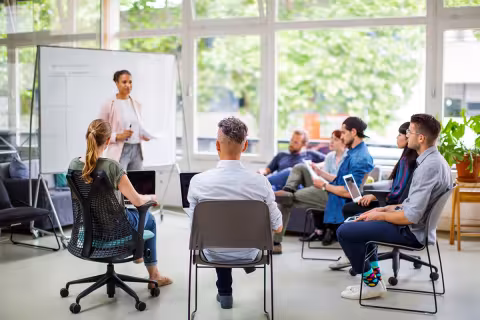 Businesswoman giving a presentation during a team meeting