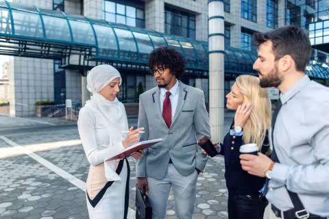Group of young professionals consulting in a city