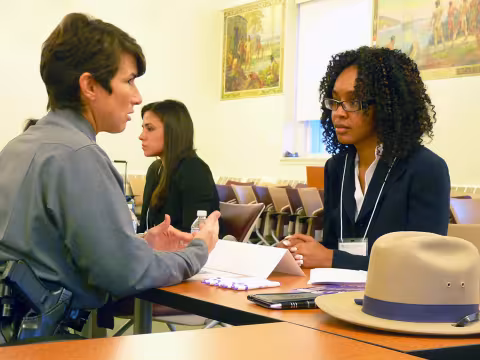 A student speaks with a police officer at a networking event
