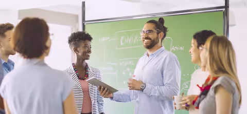 Students working with professor in class.