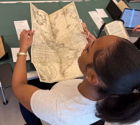 A student looking at an antiquarian map.