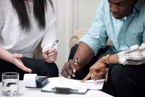 Two people filling out forms together