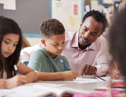 Teacher helping student in class