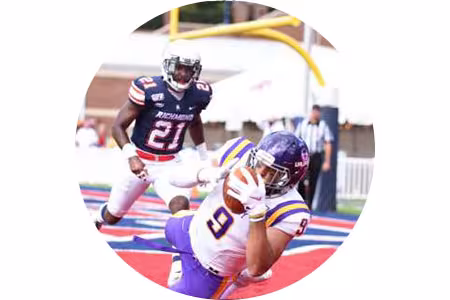 Mohammad catches a pass during a UAlbany football game.