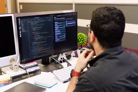 A student analyzing data on a computer monitor.