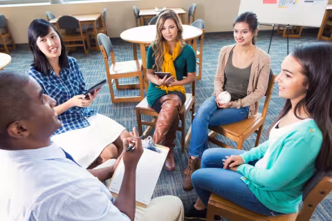 Five young adults in a group discussion