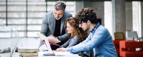 Students with their professor in a library.