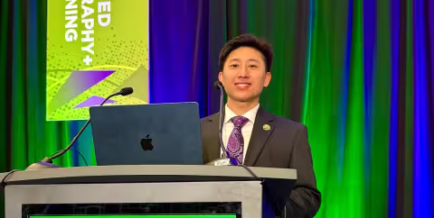 A student speaks at a podium during an event.