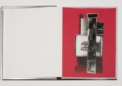 An open notebook. The left page is blank and the right page is red with back and white graphics.