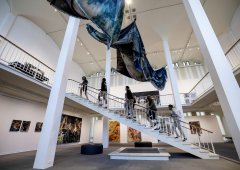 People walking up the stairs of the museum