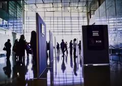 People looking at photos during the 2019 Photovoice event.