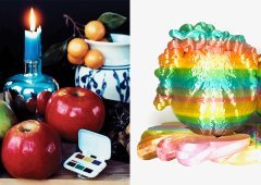 A still life next to a sculpture of some very colorful fruit.