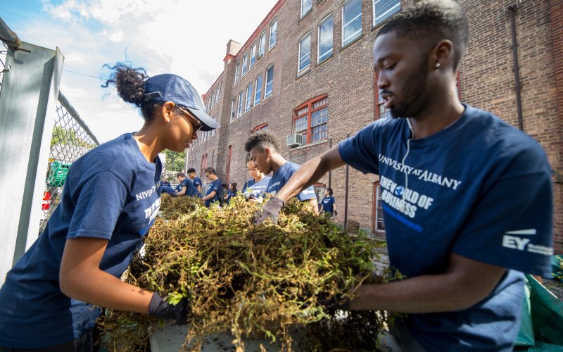 World of business student participate in living-learning community service day with yard-work