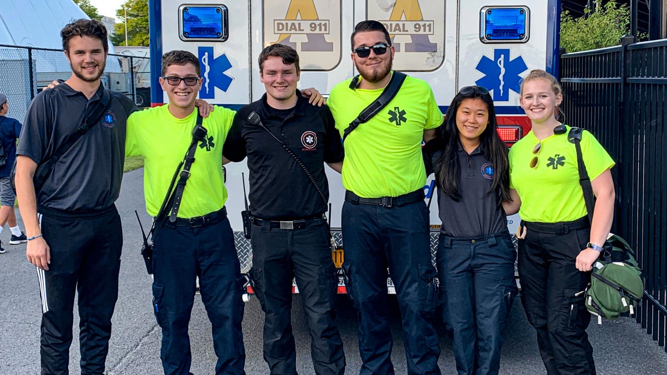 Six Five Quad volunteers pose for a photo in front of their ambulance