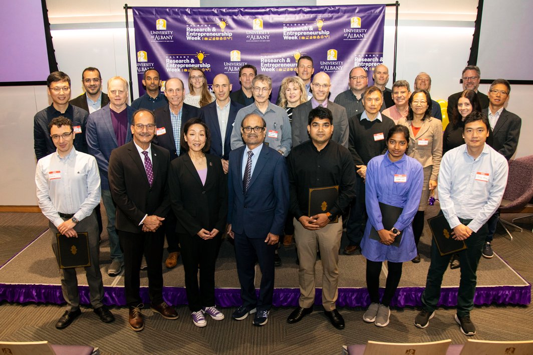 A group of award recipients smile and pose with President Havidán Rodríguez, Provost Carol Kim and Thenkurussi (Kesh) Kesavadas after the Inventor Recognition 