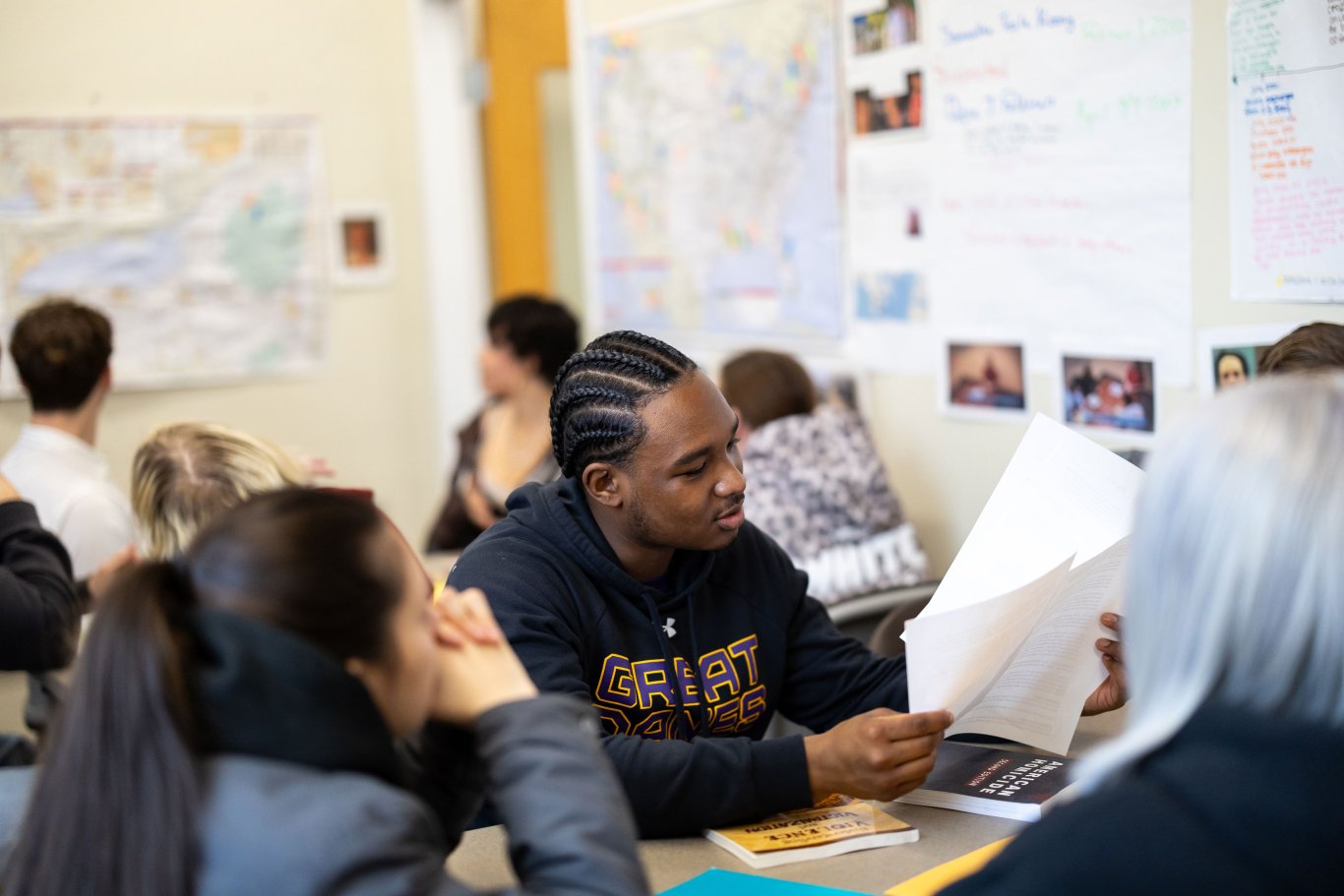 An image of two students looking at a piece of paper.