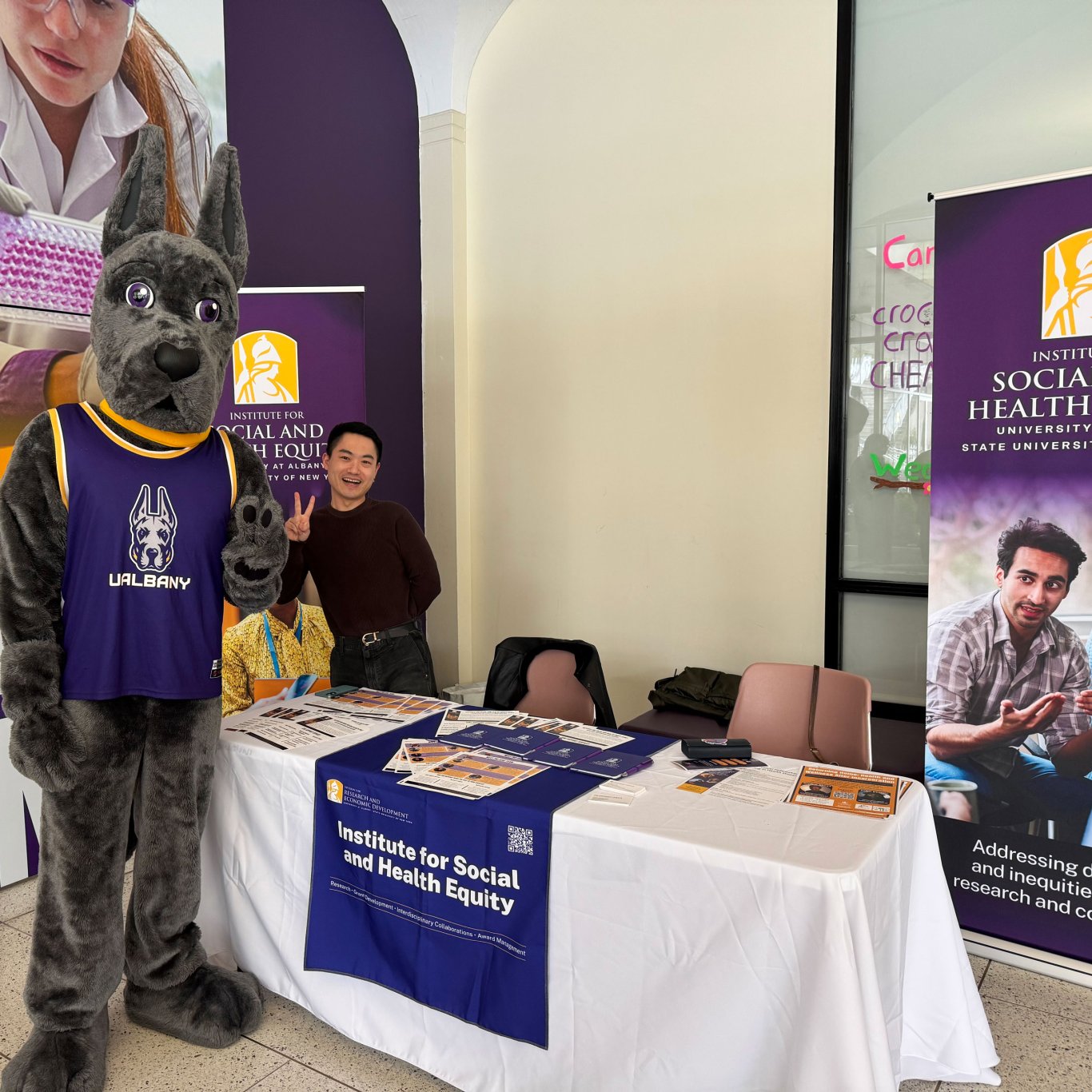 UAlbany's Damien Mascot and a faculty member from ISHE.