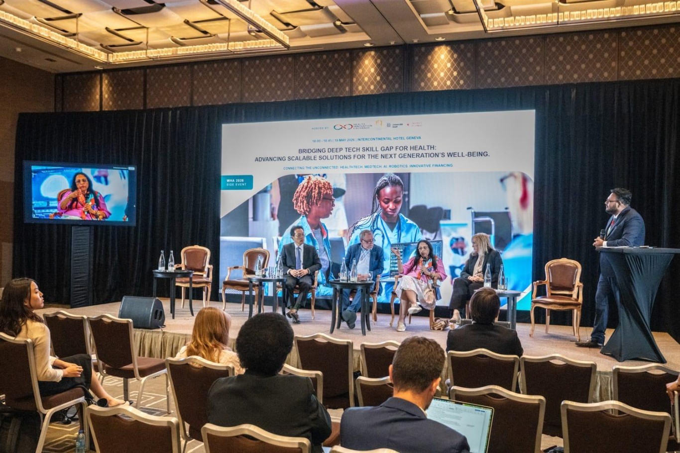 Dr. Amy Nitza, Director of the Global Center for AI in Mental Health (GCAIMH) (rightmost seated participant) presents TherAssist during a panel discussion on the role of AI.