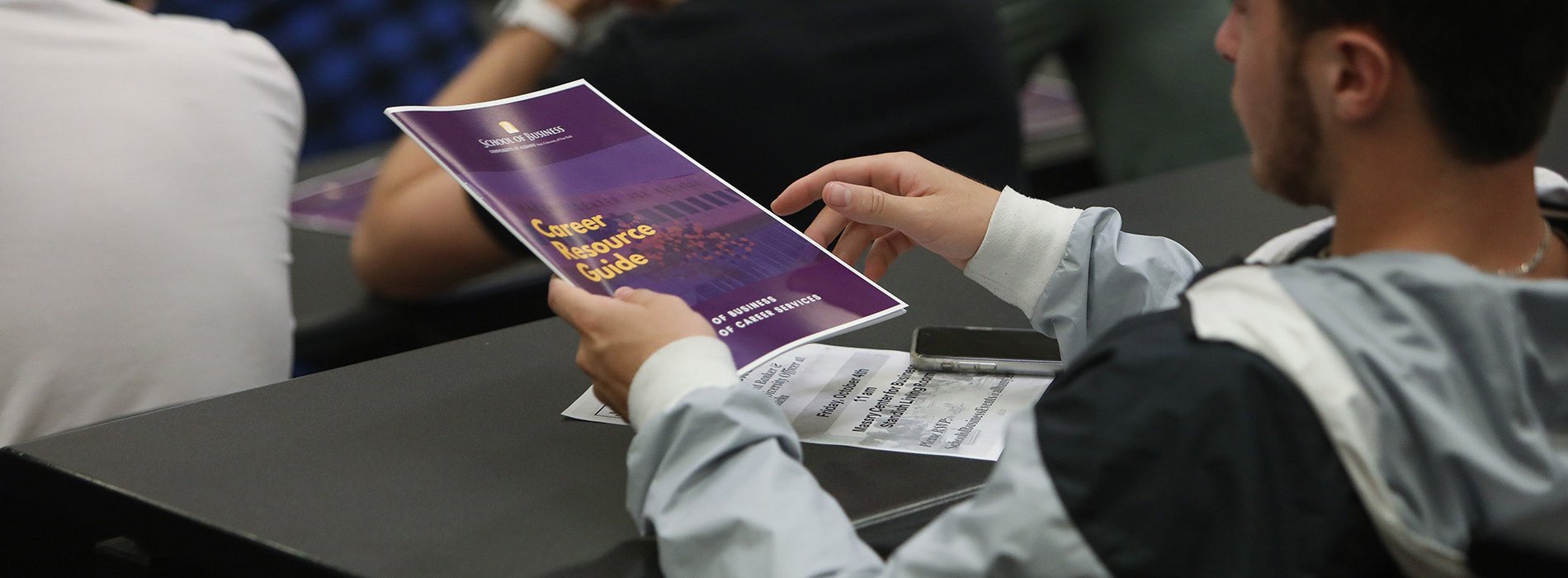 Student holding career guide