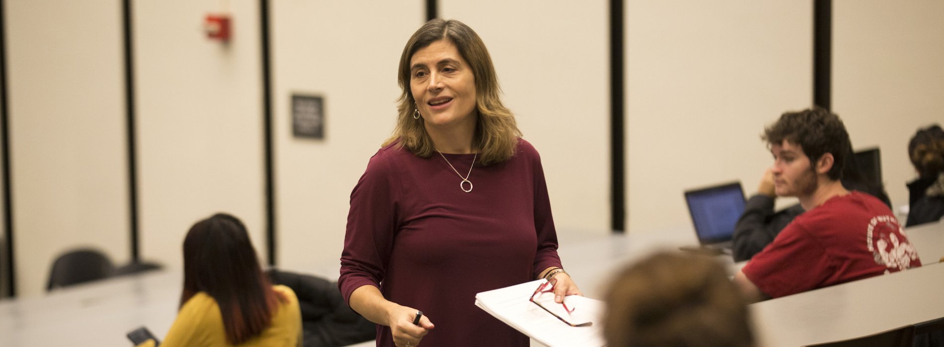 Dr. Erin Bell teaching a classroom of students in a lecture hall