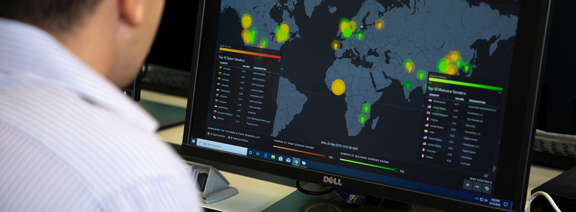 Man sitting at computer showing world map