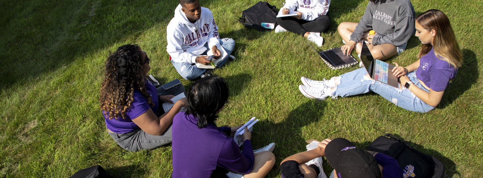 Students gathered in a circle outside to study