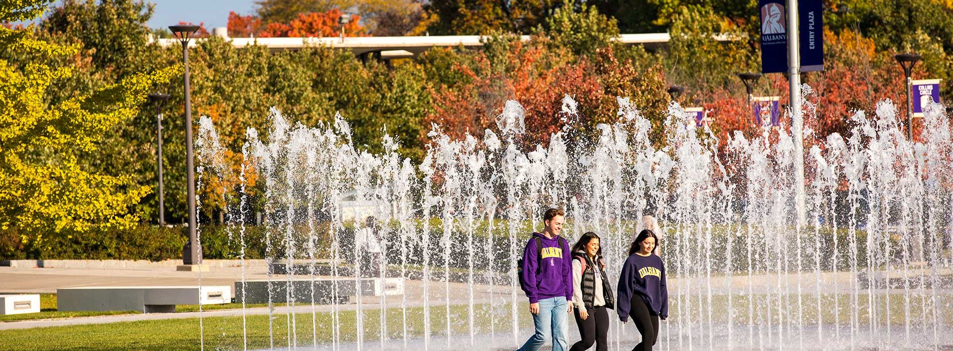 Three students walking together on campus.
