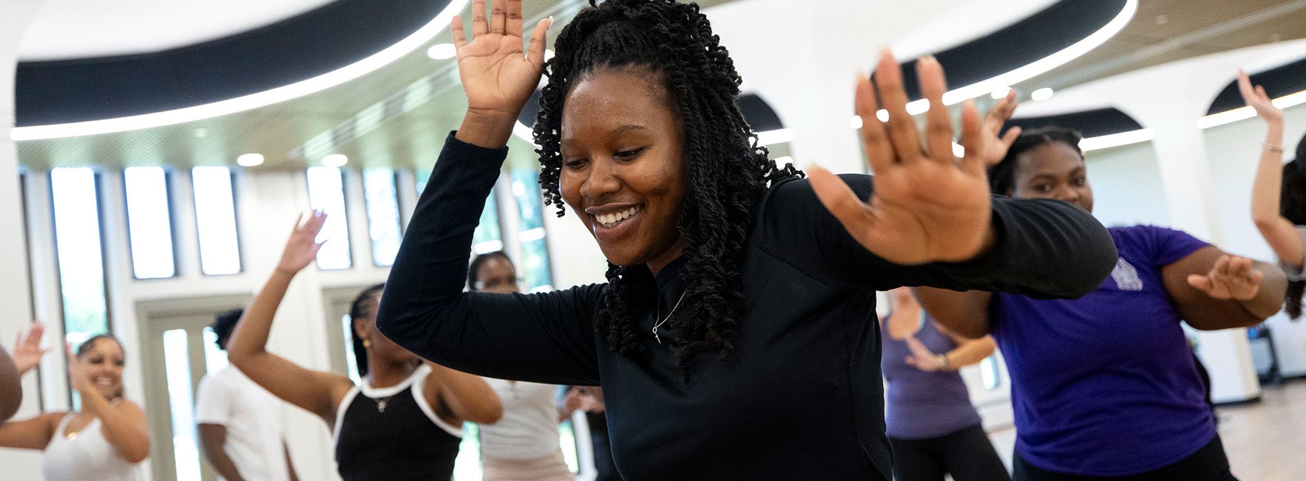 Students dancing together in a class at the Well.
