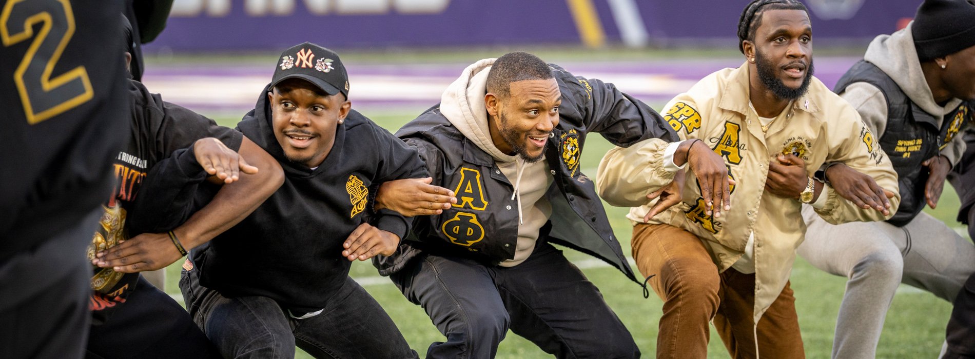 Alumni members of Alpha Phi Alpha Fraternity, Inc. perform their stroll on Bob Ford Field.