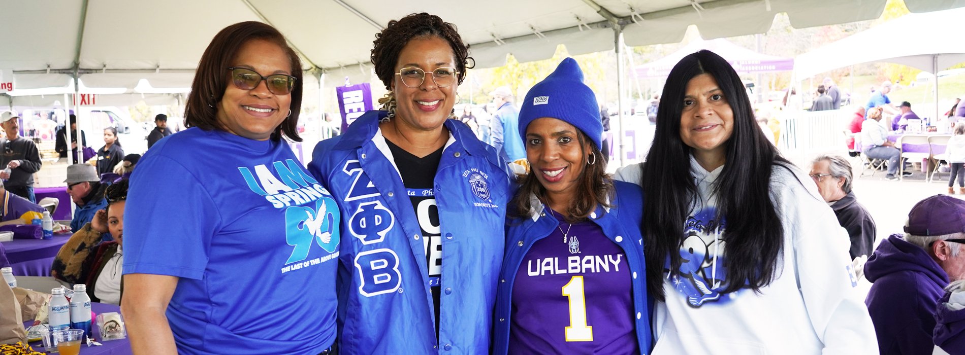 Zeta Phi Beta alumni pose for a photo under a tent at Casey Stadium.