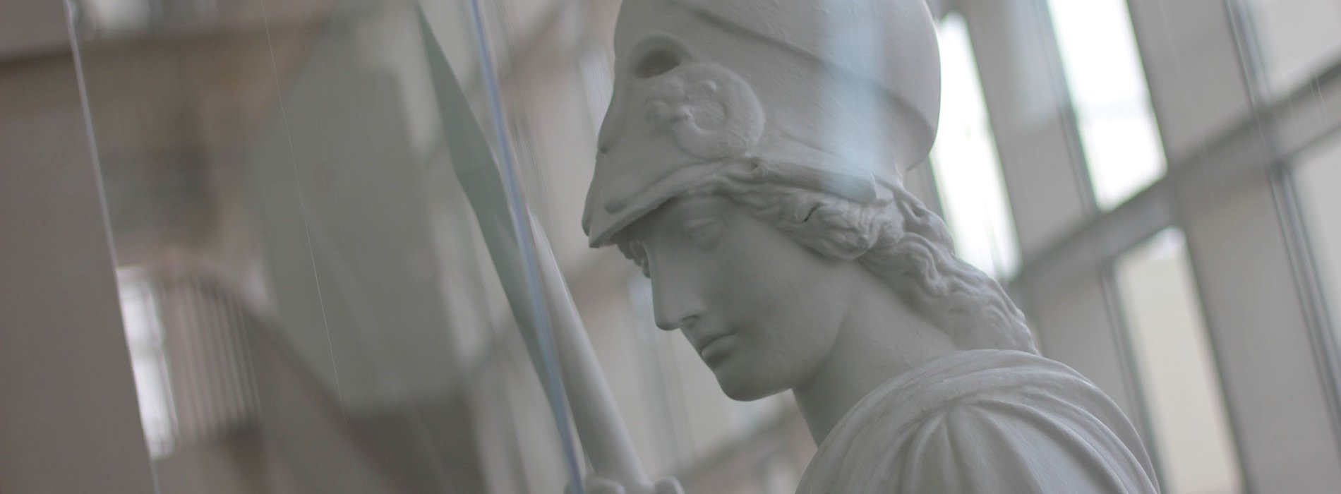 White statue of Minerva with windows behind her
