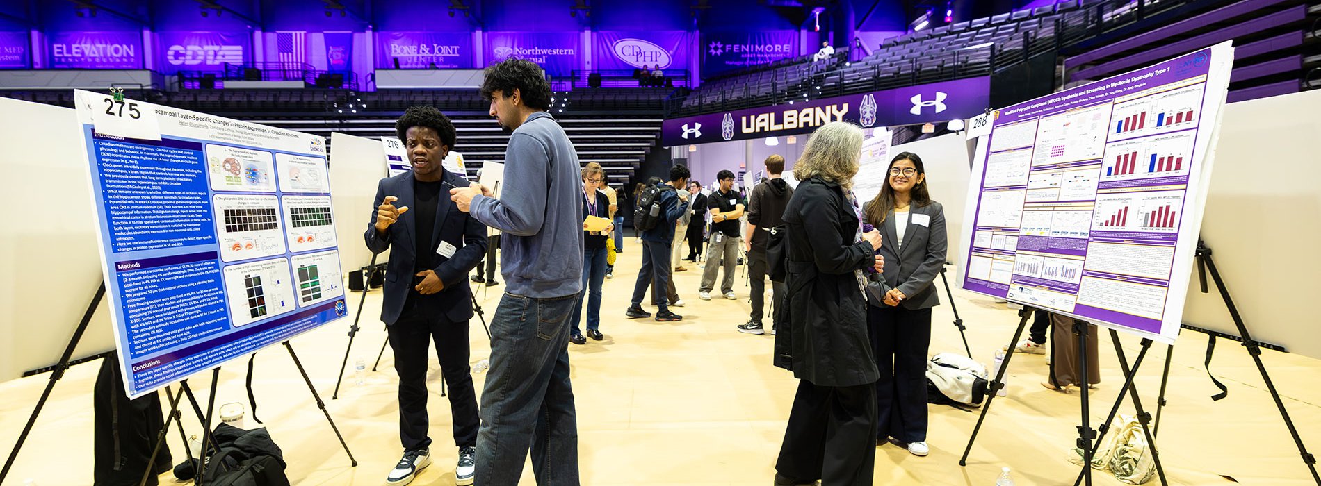 Students presenting research posters in the Broadview Arena during Showcase Day.