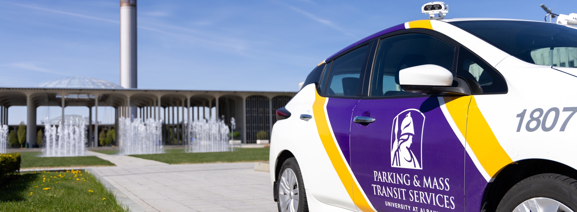 An electric parking facilitaion vehicle sits parked in front of Campus Center.