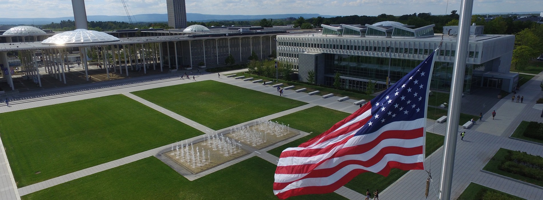 An American flag flies in front of UAlbany's Massry School of Business.