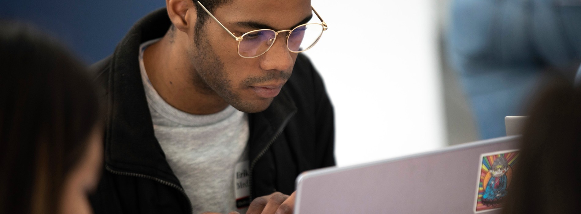 A student works on a laptop.