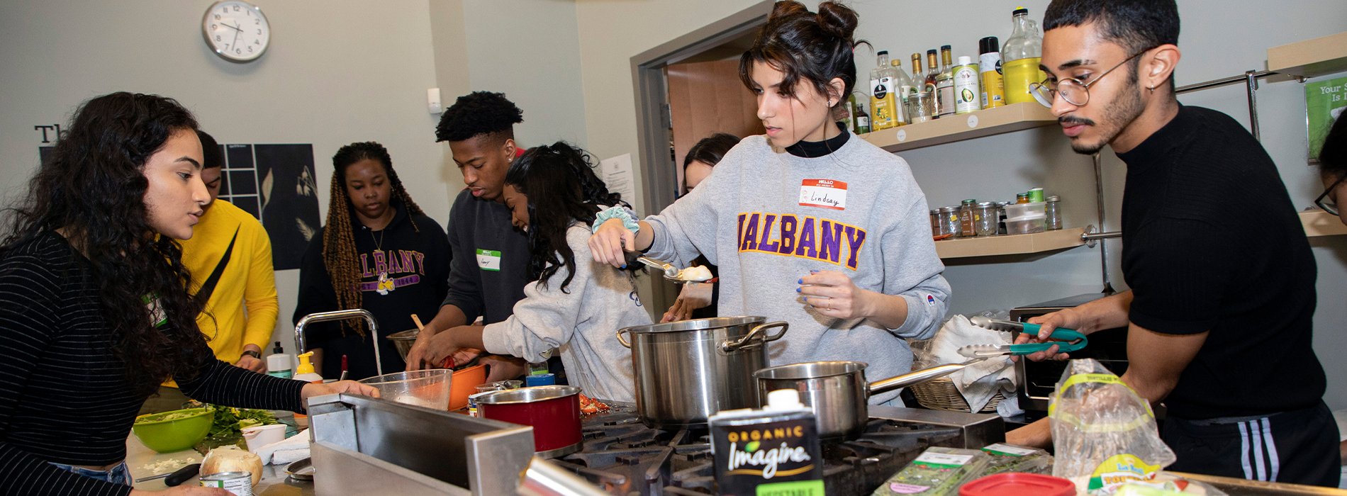 UAlbany students prepare food at the Honest Weight Food Coop kitchen