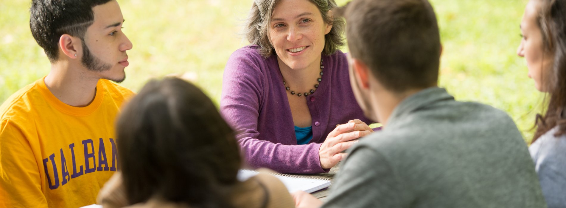 A faculty member teaches students outside