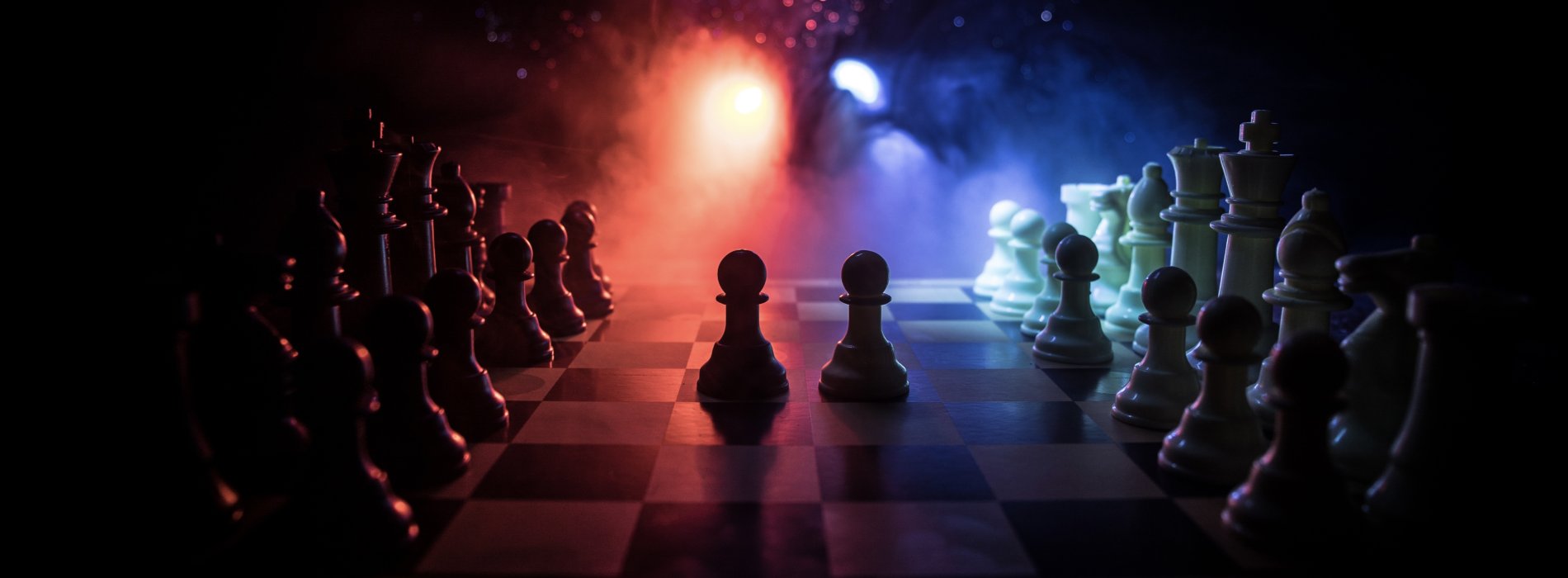 Two chess are highlighted on a chess board with a vibrant light in the background