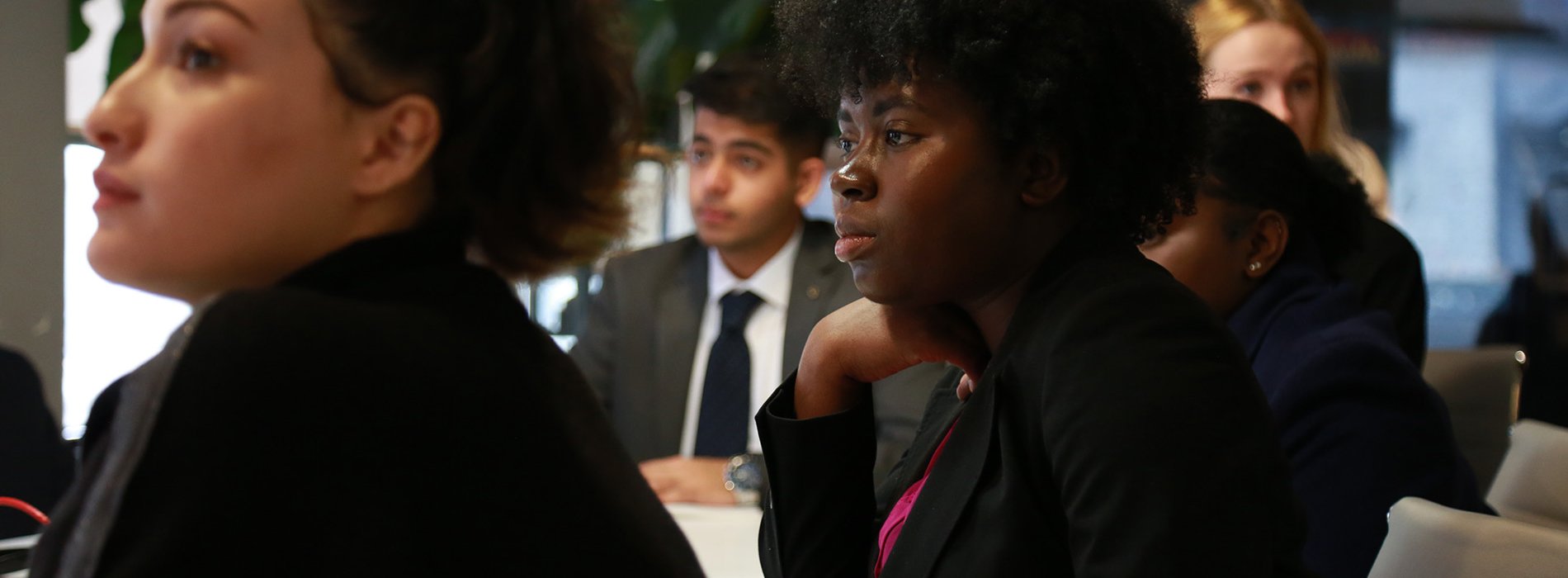 Students listening to speaker at meeting 