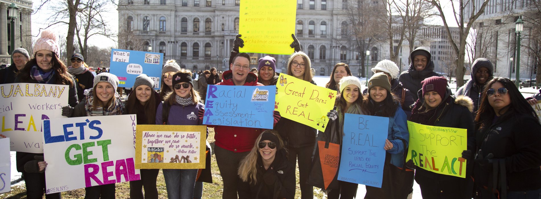 SSW students holding advocacy posters while attending LEAD Day at the New York State Capitol