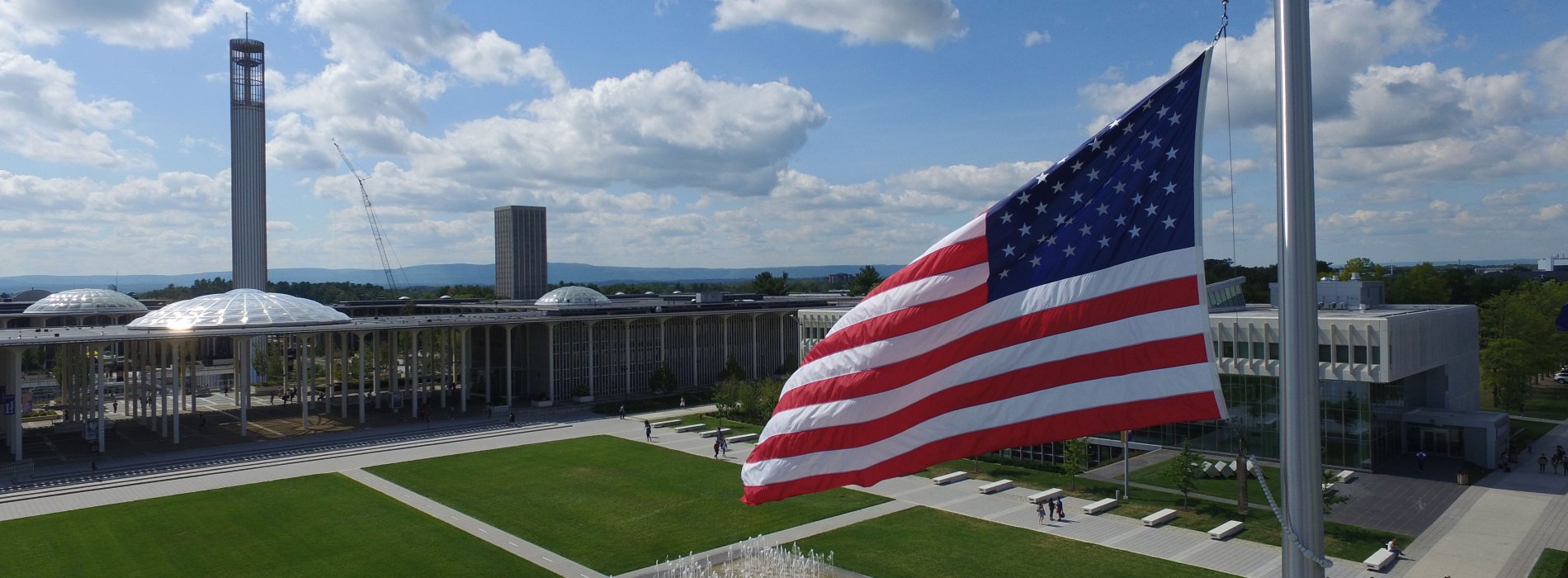 An American flag flying over UAlbany's Academic Podium on the Uptown Campus.