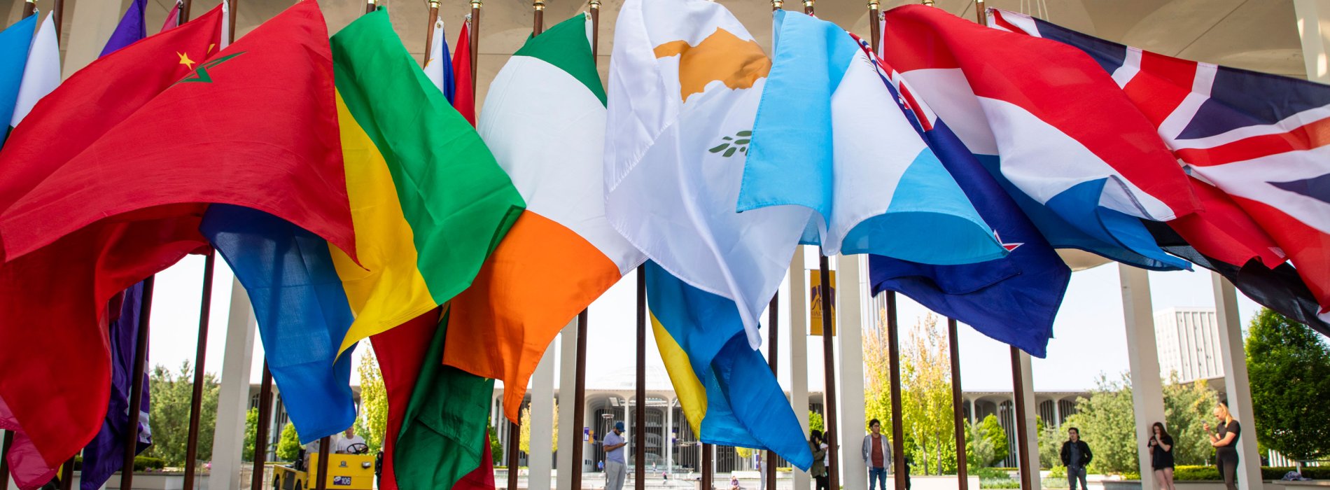 A line of international flags wave in the wind on the Academic Podium.